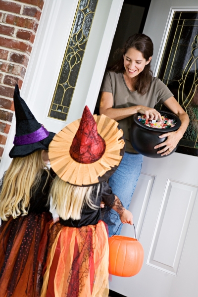 kids receiving Halloween candy while trick-or-treating