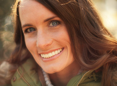 woman smiling after getting porcelain veneers