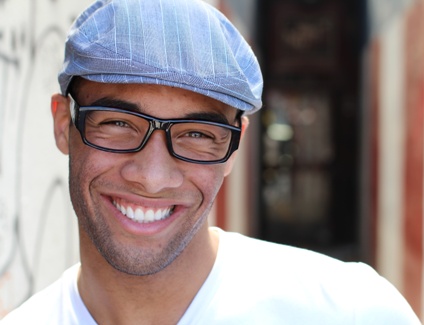 young man showing results of smile makeover