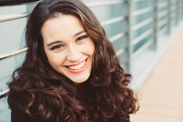 woman smiling after undergoing a cosmetic dentistry treatment